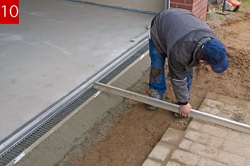 Ermitteln bzw. festlegen der Gefällesituation. Das Pflaster so anarbeiten, dass der Rinnenstrang 3-5 mm unterhalb des Pflasters verläuft