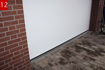 Der fertiggestellte Rinnenstrang in der Pflasterfläche vor der Garage entlastet die Schwelle und verhindert aufspritzendes Wasser im Torbereich